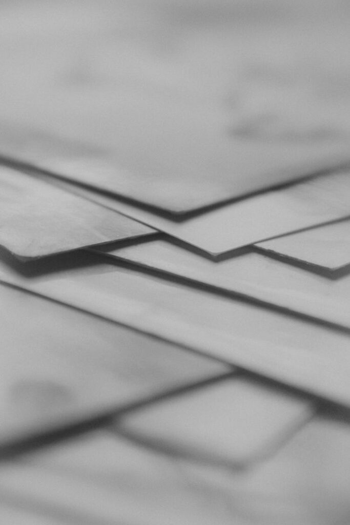 pexels-photo-14303756-14303756 Close-up of overlapping paper layers in grayscale, creating an abstract artistic effect.